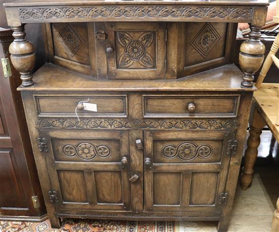 A reproduction carved and panelled oak court cupboard, W.3ft 8in.